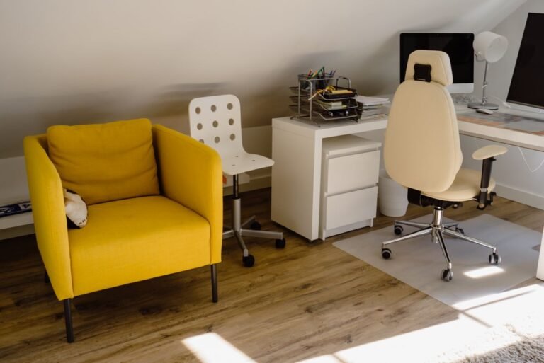 An armless office chair at a desk in a bright small space