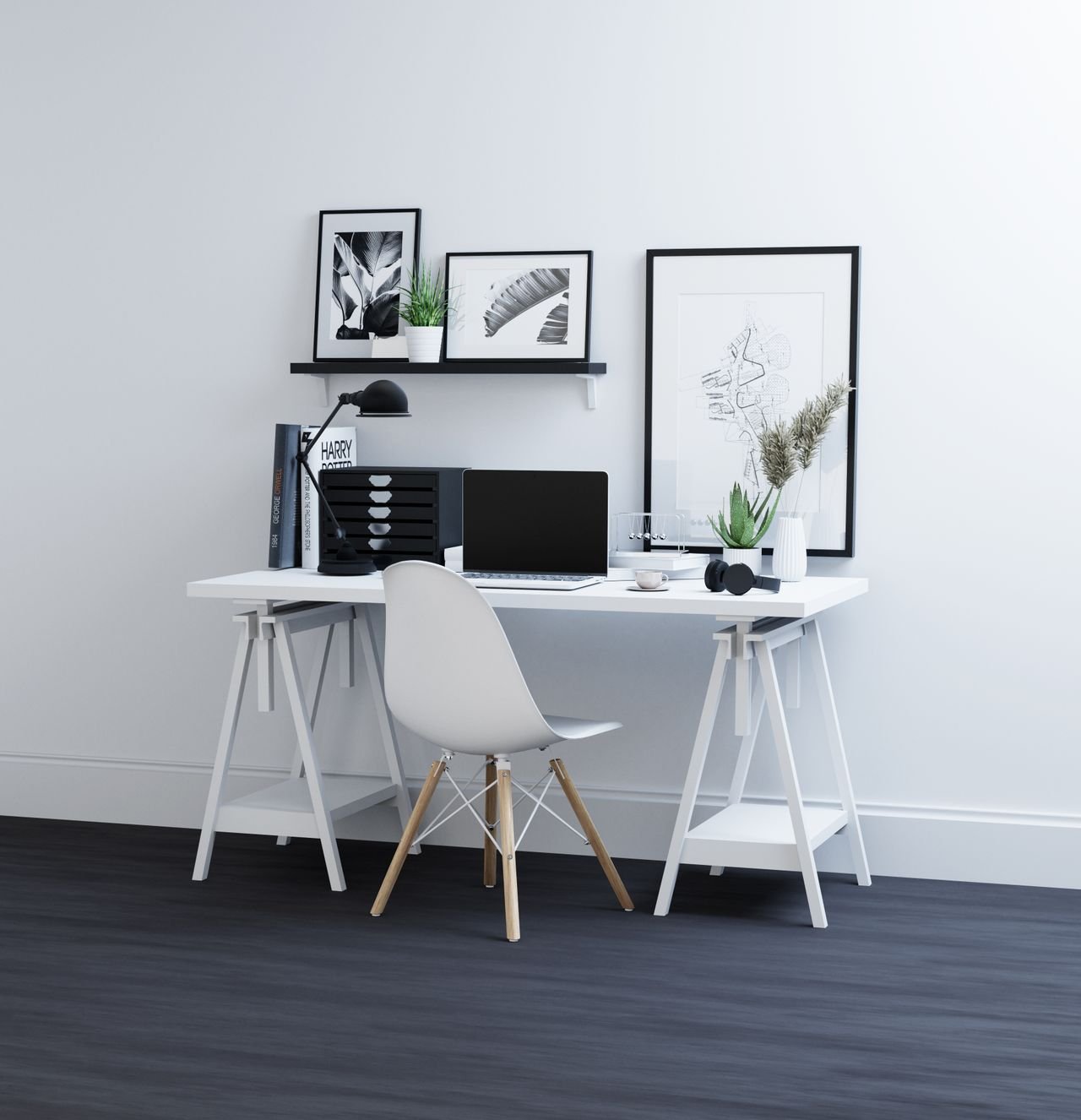A cozy small home office with a light-wood desk, plants and framed wall art
