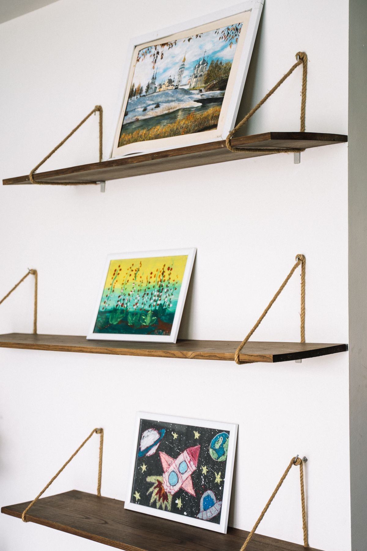 Floating wall shelves styled with books and a plant