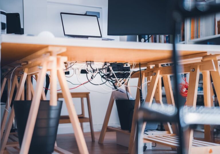 A simple light-wood folding-style desk in a bright room