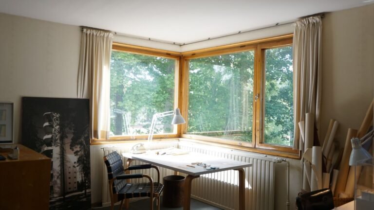 A wall-mounted folding desk in a bright room by a window