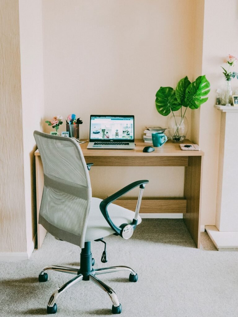 A compact white desk chair at a small bright workspace