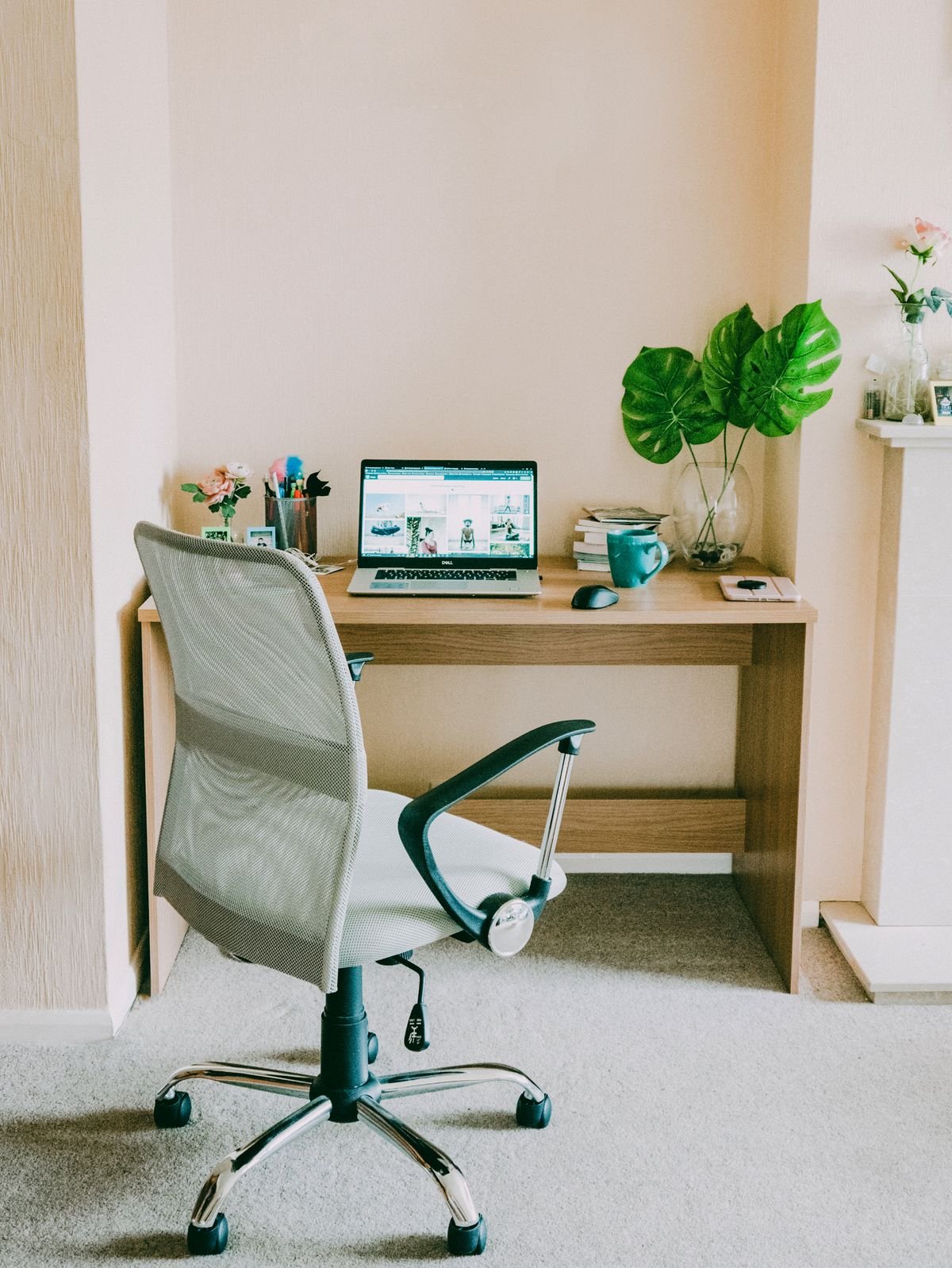 A compact white desk chair at a small bright workspace