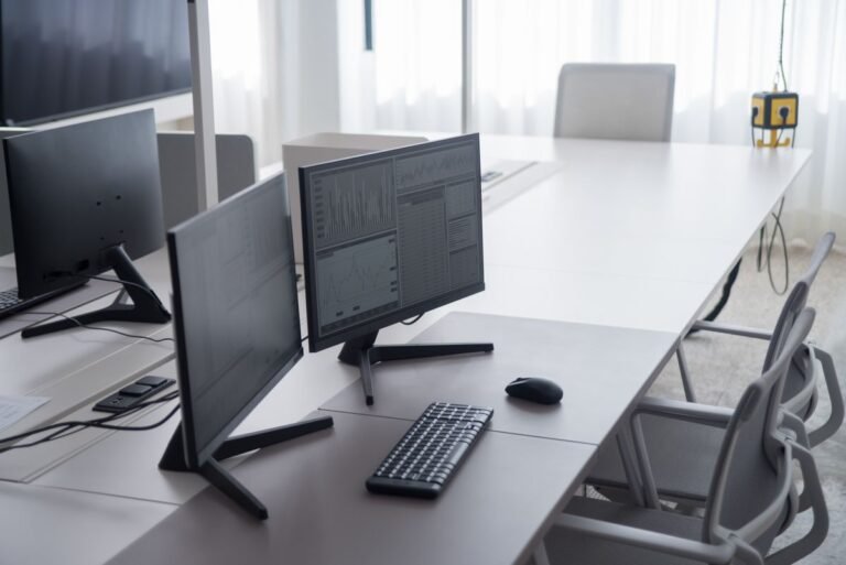 A bright dual-monitor mini PC workstation on a clean white desk