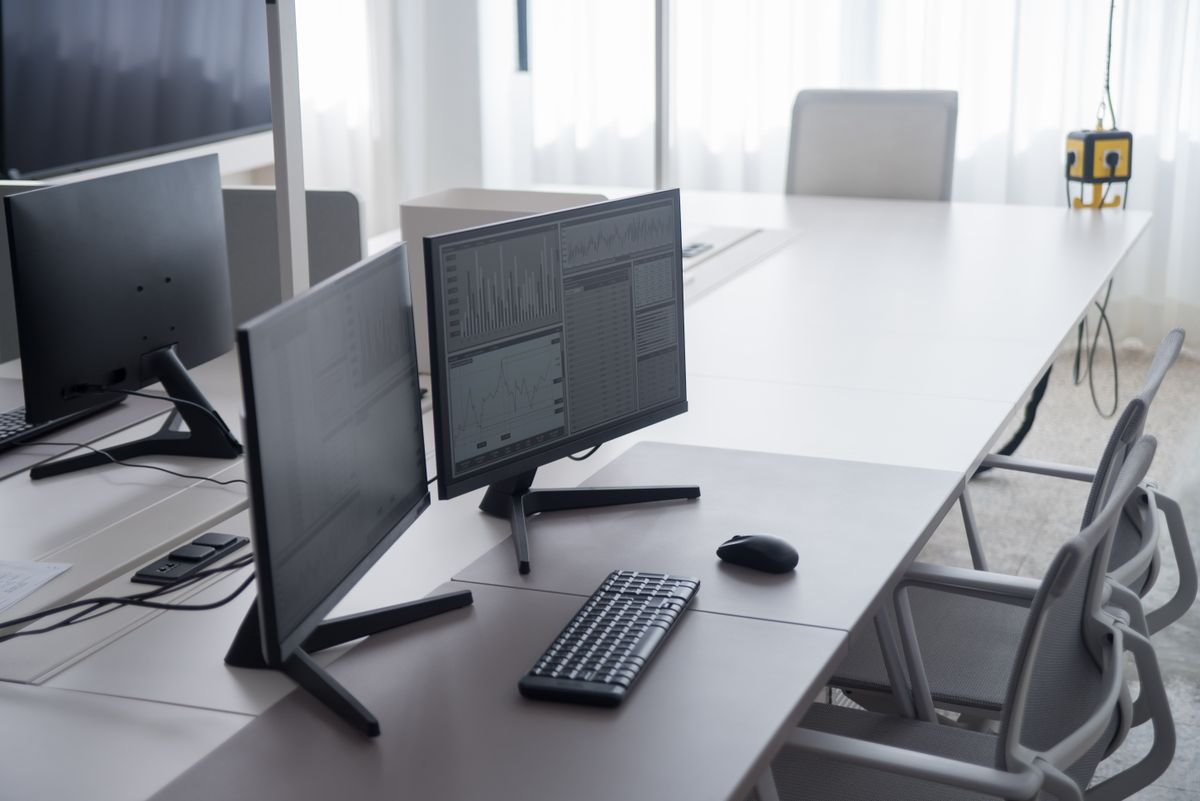 A bright dual-monitor mini PC workstation on a clean white desk
